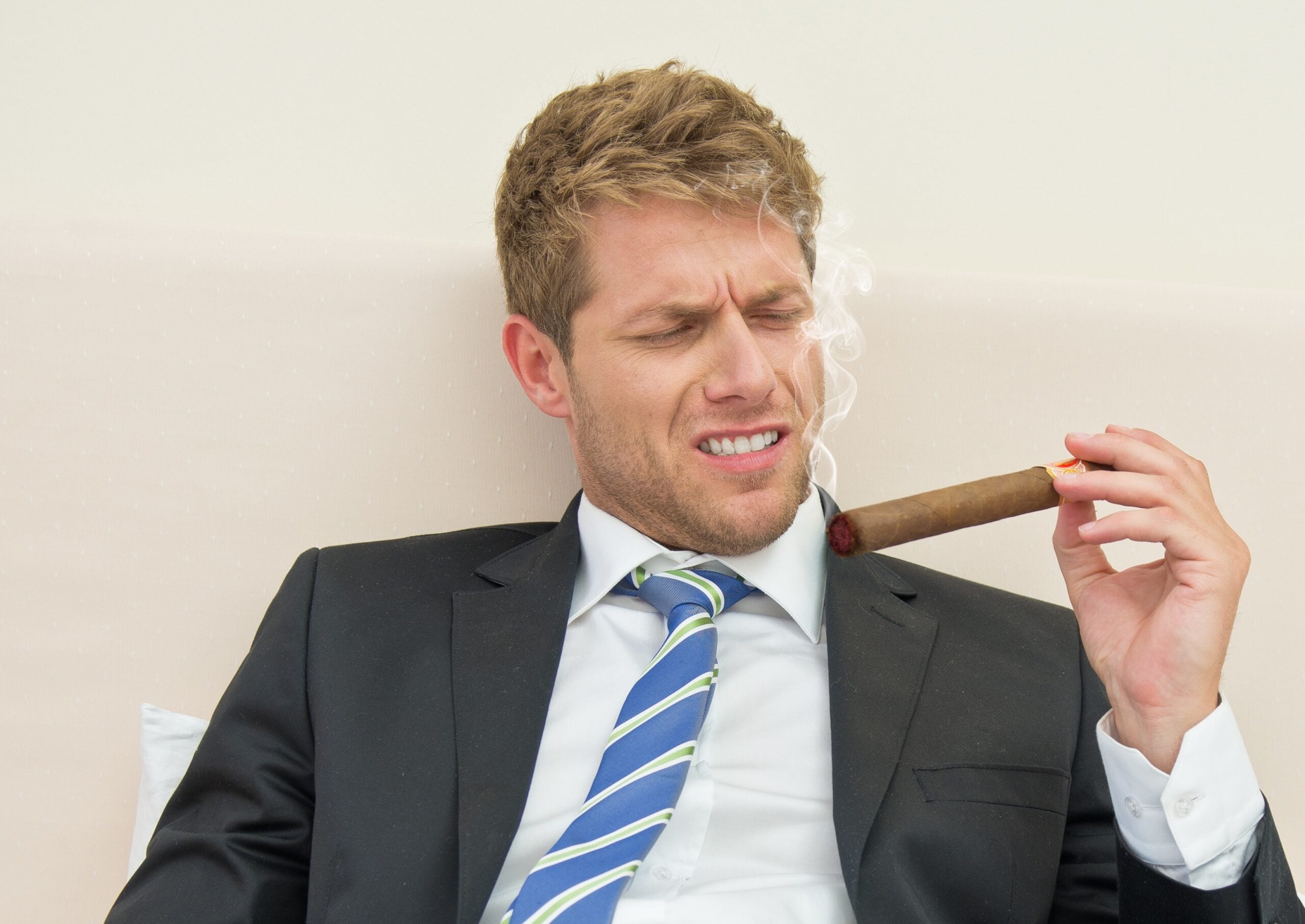man smoking a cigar he doesn't like